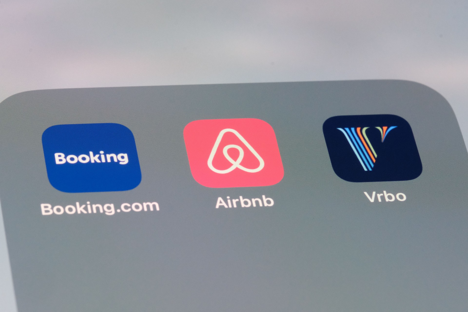 Airbnb, Booking.com and Vrbo apps. Assorted online rental brands